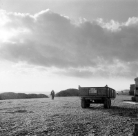 Woman and trailer on beach